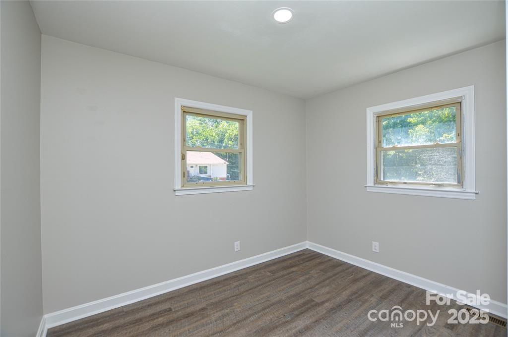 116 Brymer Road Gastonia, NC 28056 - Photo 4 of 21 a view of an empty room with wooden floor and a window