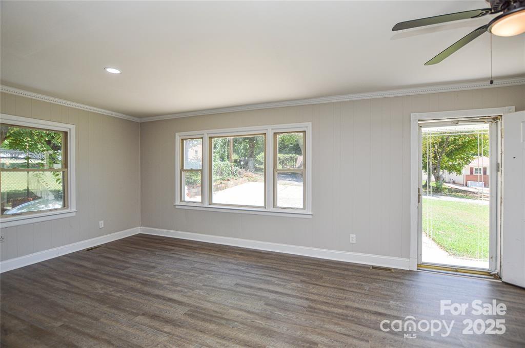 116 Brymer Road Gastonia, NC 28056 - Photo 5 of 21 a view of an empty room with wooden floor and a window
