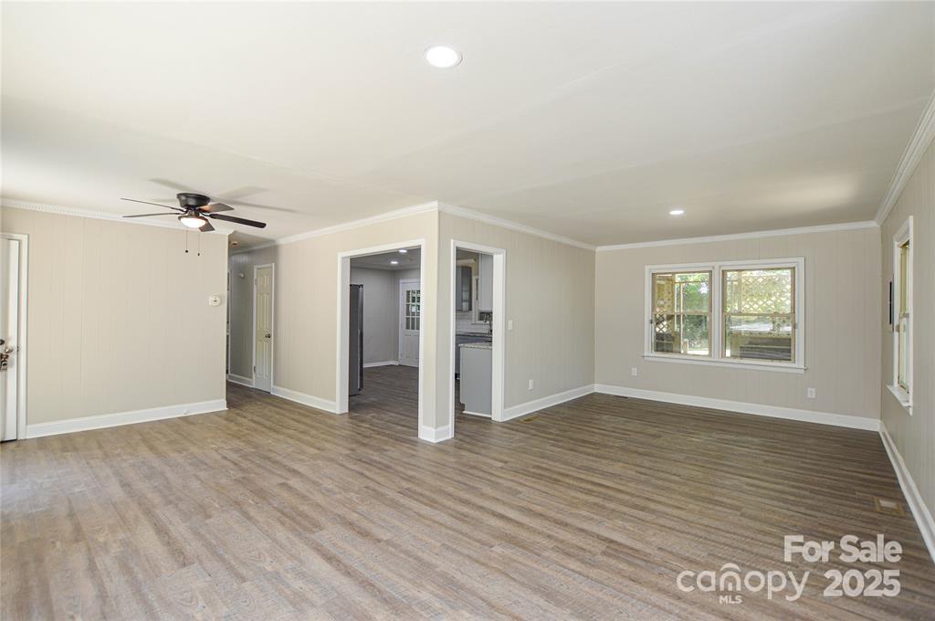 116 Brymer Road Gastonia, NC 28056 - Photo 7 of 21 an empty room with wooden floor and windows