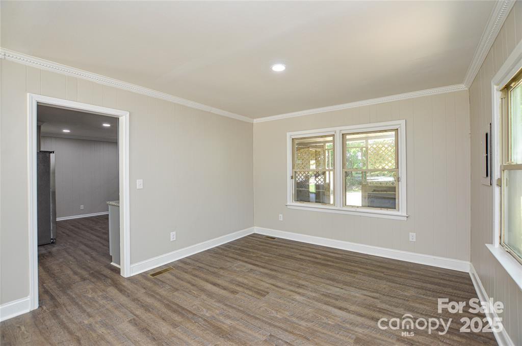 116 Brymer Road Gastonia, NC 28056 - Photo 8 of 21 an empty room with wooden floor and windows