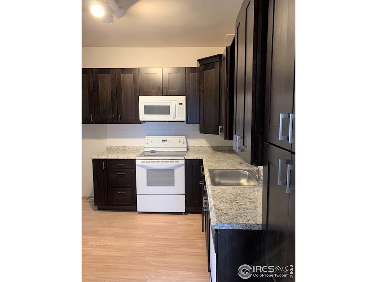 a kitchen with stainless steel appliances granite countertop a refrigerator and a stove