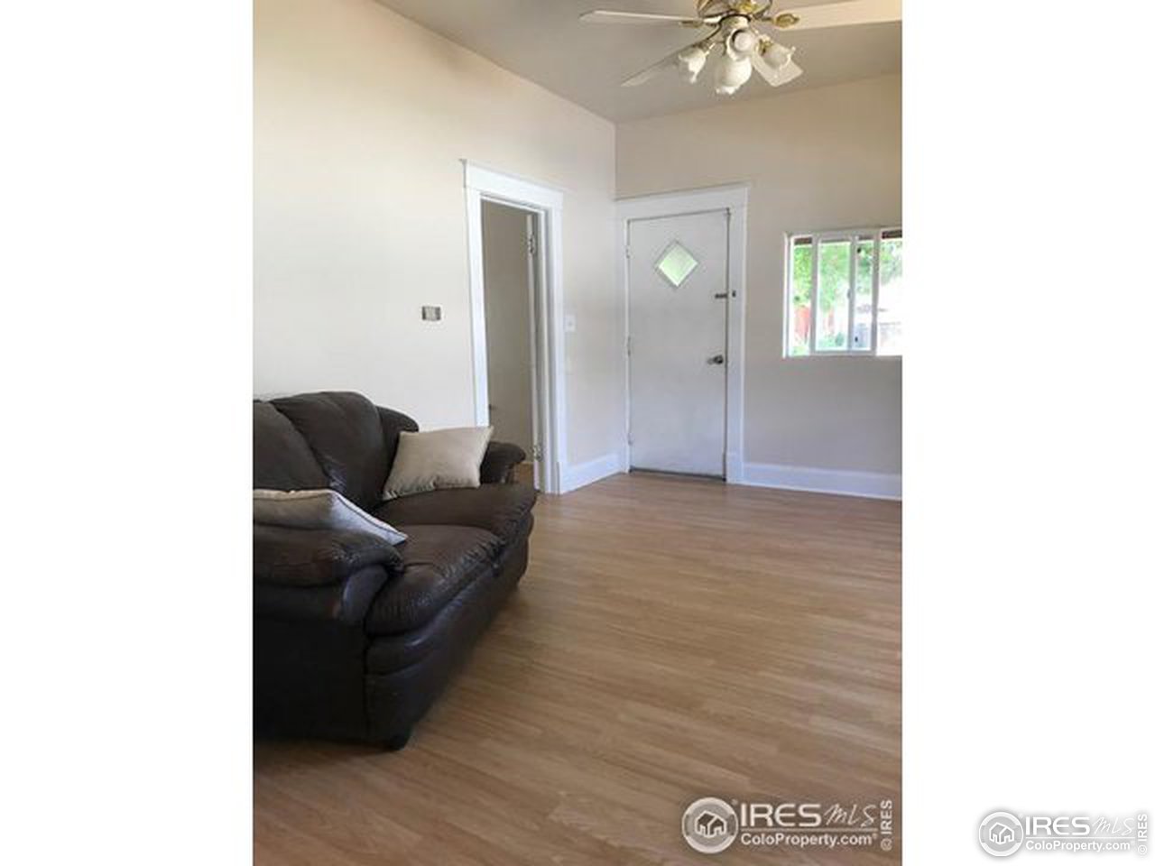 316 Walnut Street Fort Morgan, CO 80701 - Photo 12 of 22 a living room with furniture and a chandelier