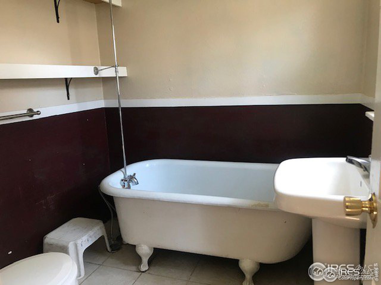 316 Walnut Street Fort Morgan, CO 80701 - Photo 15 of 22 a bathroom with a sink a toilet and a bathtub