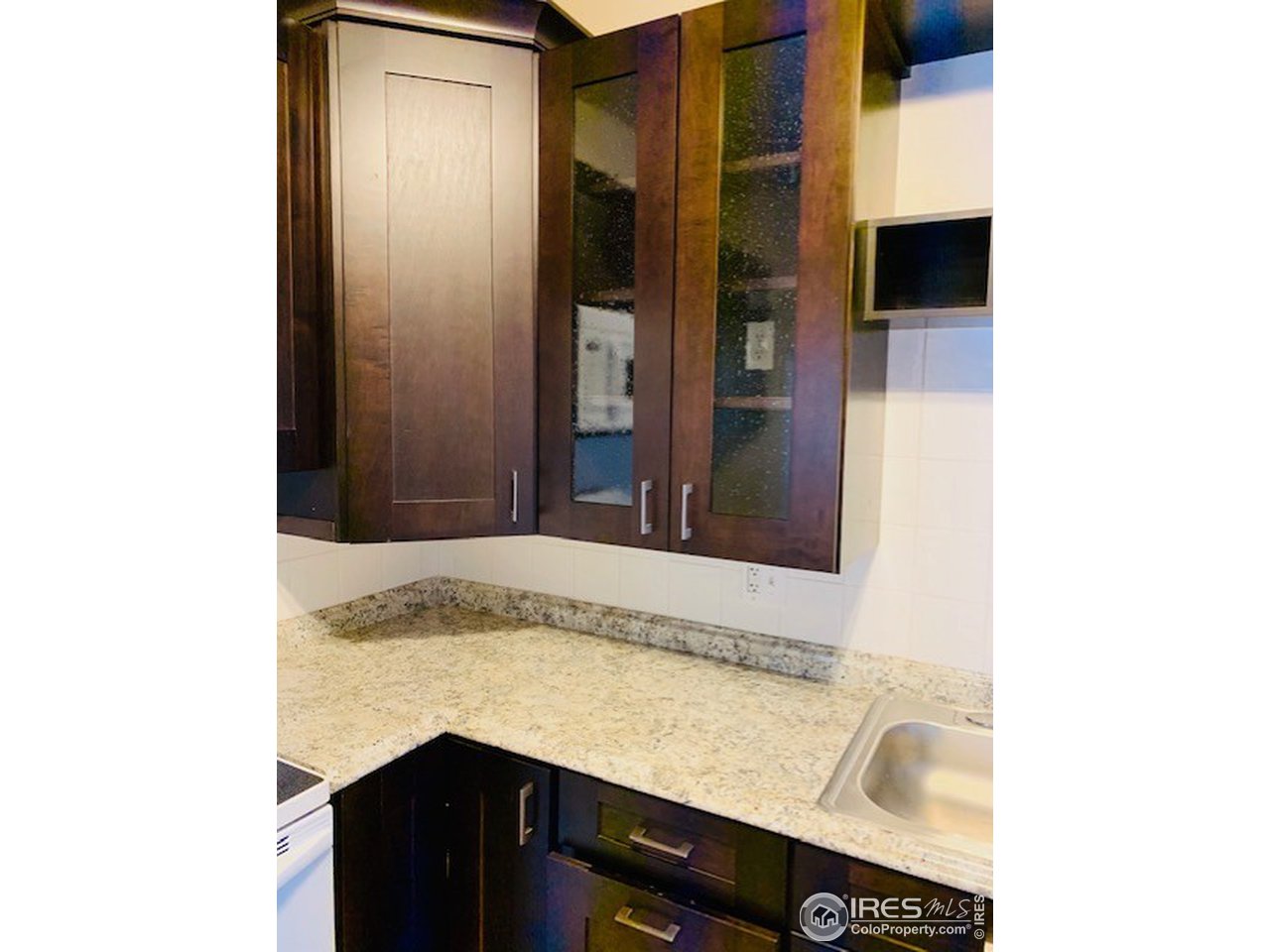 316 Walnut Street Fort Morgan, CO 80701 - Photo 5 of 22 a bathroom with a granite countertop sink and a mirror