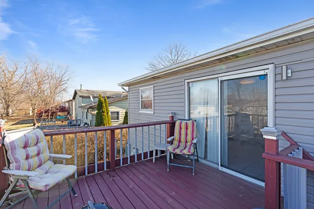a roof deck with table and chairs and wooden floor
