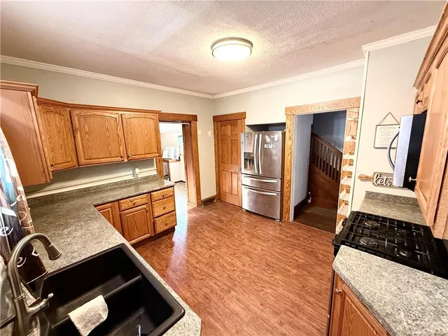 a kitchen with stainless steel appliances granite countertop a stove and a refrigerator
