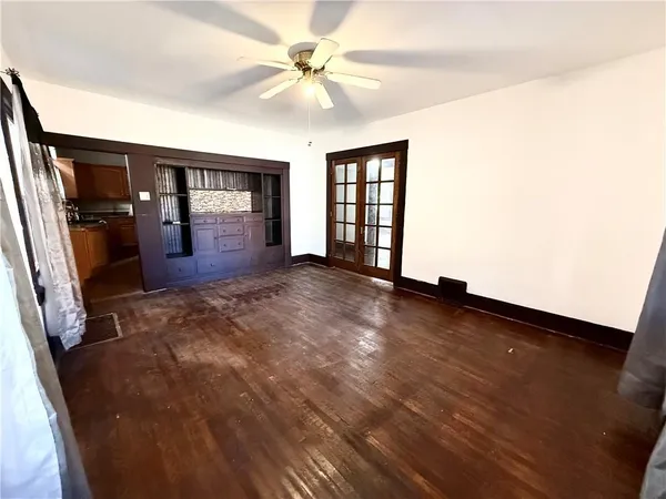 wooden floor in an empty room with a window