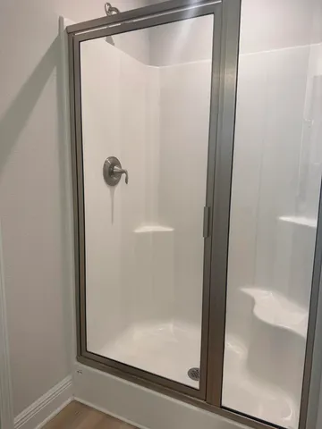 a bathroom with a glass shower door