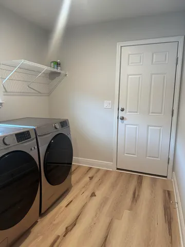 a view of a storage and utility room with washer and dryer