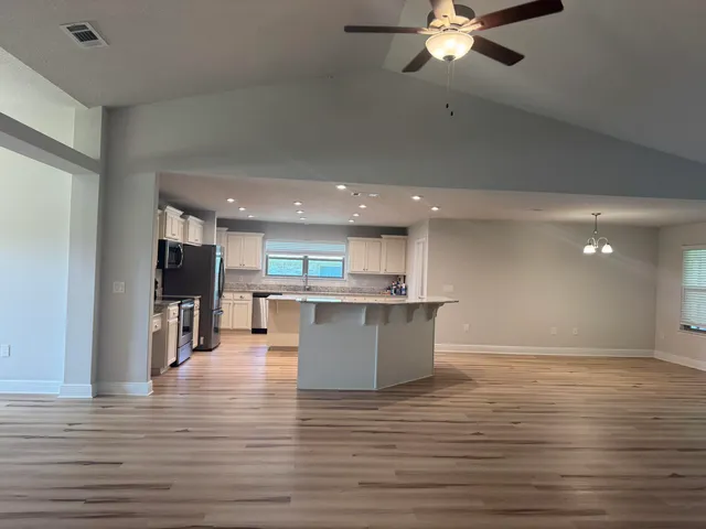 a view of kitchen and window with wooden floor