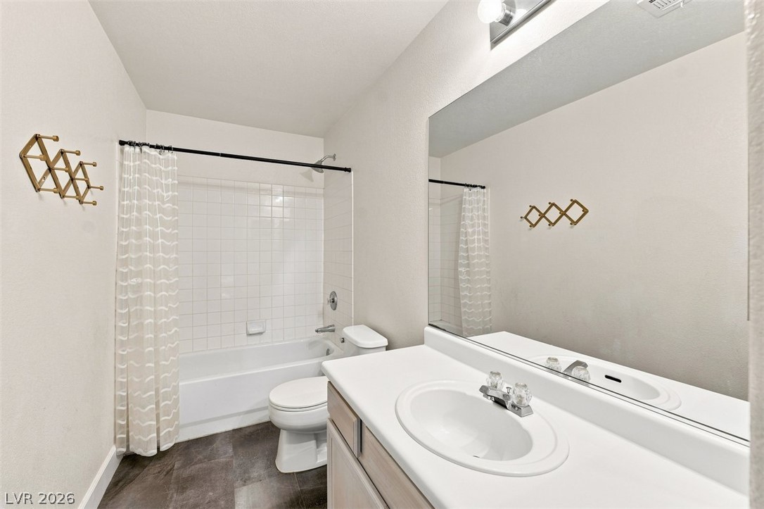 505 Rafkin Place Henderson, NV 89052 - Photo 23 of 35 Functional full guest bathroom featuring a tub and shower combination with a vanity sink and expansive mirror.