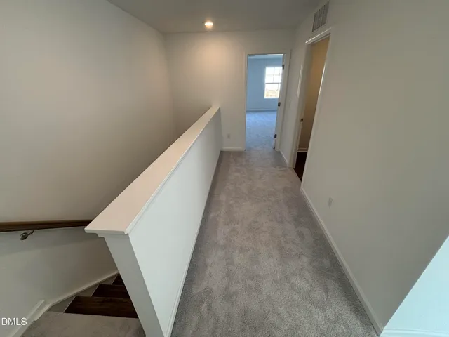 a view of a hallway with seating area