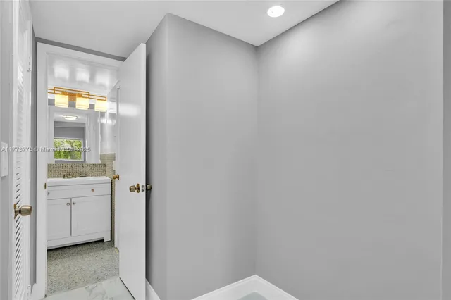 a bathroom with a glass shower door and a sink
