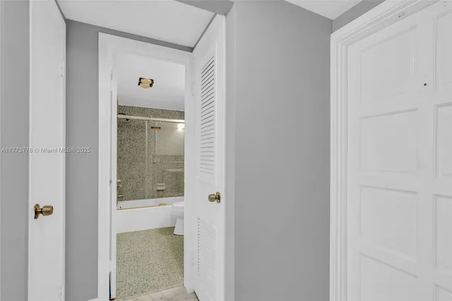 a bathroom with a sink mirror bathtub and toilet