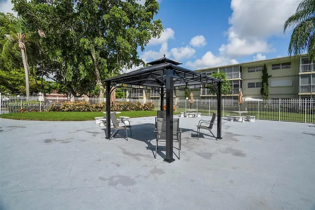 a view of a house with porch and garden
