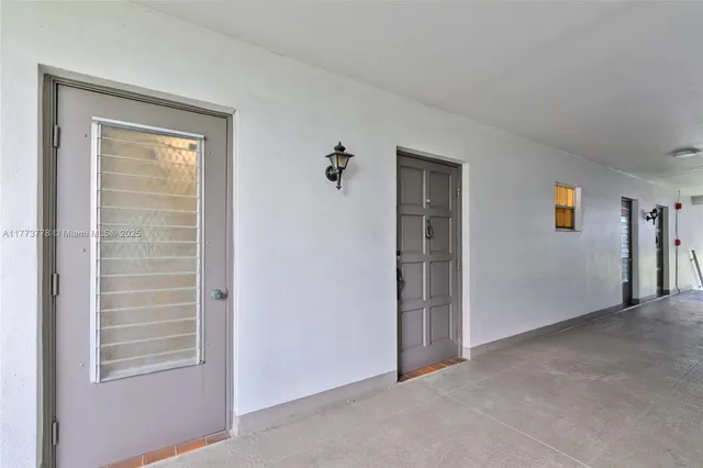 a front view of multi story residential apartment building with yard and sign board