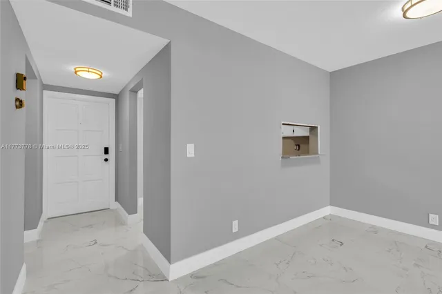 a view of an empty room with a window