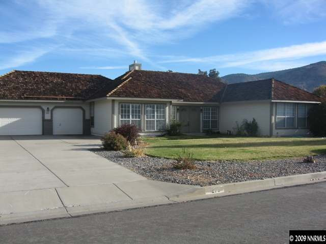 1275 High Chaparral Drive Reno, NV 89521 - Photo 1 of 9 a front view of a house with a garden