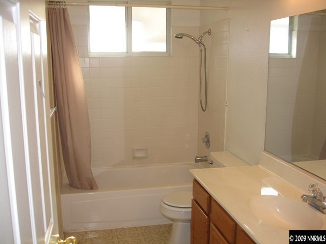 1275 High Chaparral Drive Reno, NV 89521 - Photo 8 of 9 a bathroom with a granite countertop sink toilet and shower