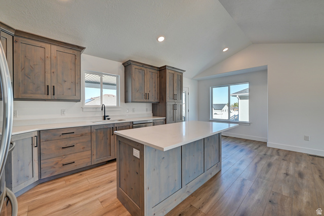 1848 Mantle Way, Unit 417 Tooele, UT 84074 - Photo 5 of 6 Kitchen featuring wood-finish cabinetry, light-toned countertops, and wood-finish flooring