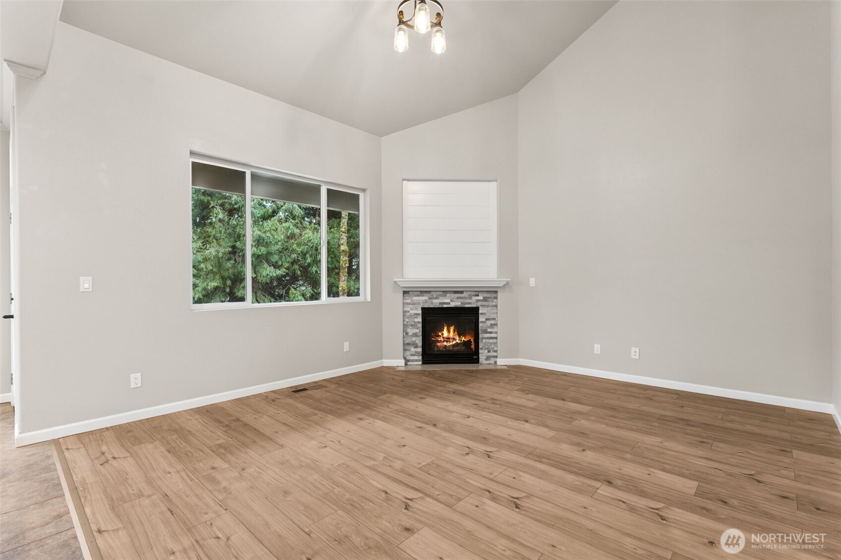 9248 Periwinkle Loop Northeast Olympia, WA 98516 - Photo 12 of 39 a view of an empty room with wooden floor and a window