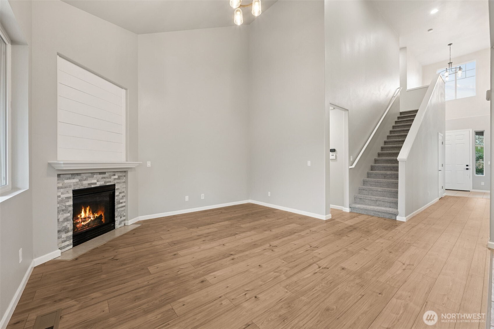 9248 Periwinkle Loop Northeast Olympia, WA 98516 - Photo 13 of 39 a view of empty room with wooden floor and fireplace