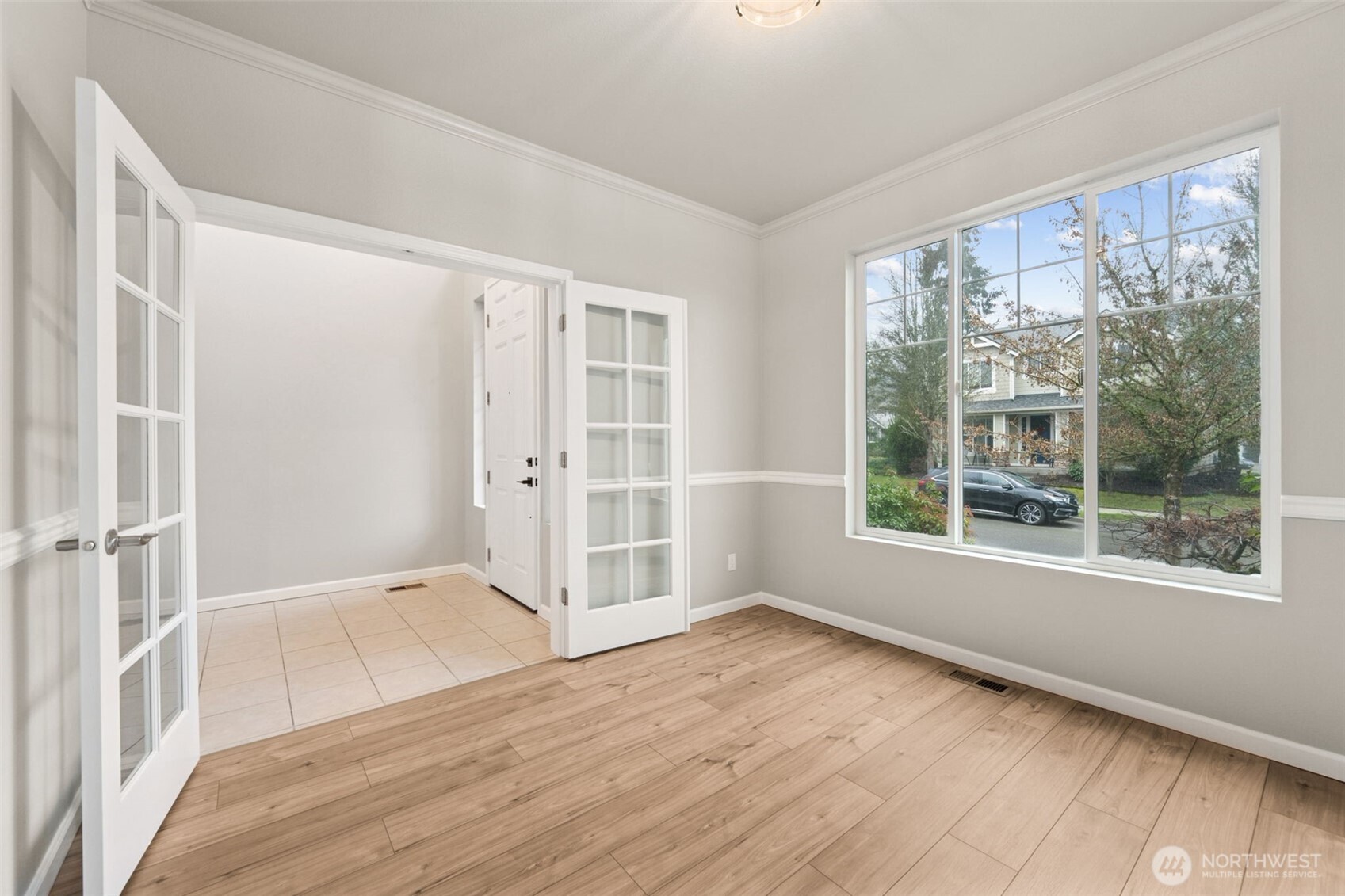 9248 Periwinkle Loop Northeast Olympia, WA 98516 - Photo 4 of 39 an empty room with wooden floor and windows