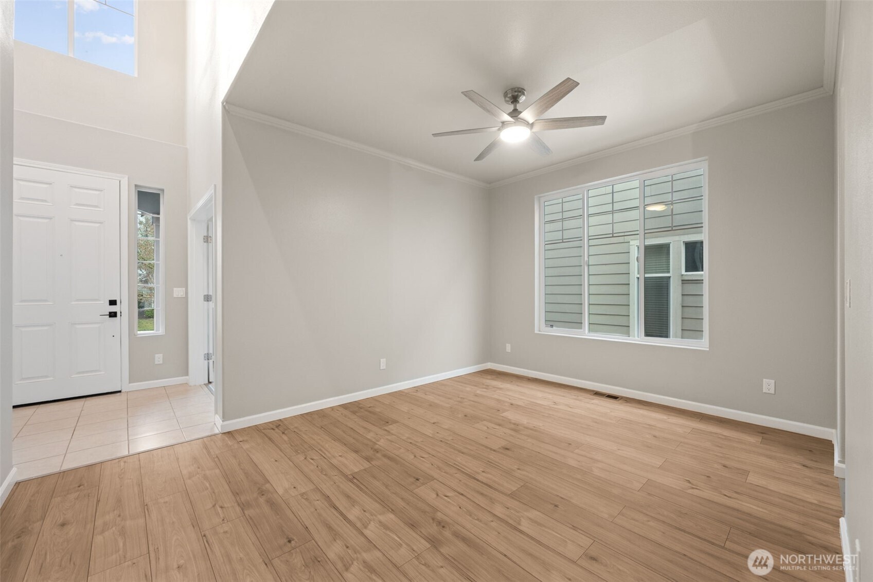 9248 Periwinkle Loop Northeast Olympia, WA 98516 - Photo 5 of 39 a view of an empty room with wooden floor and a window