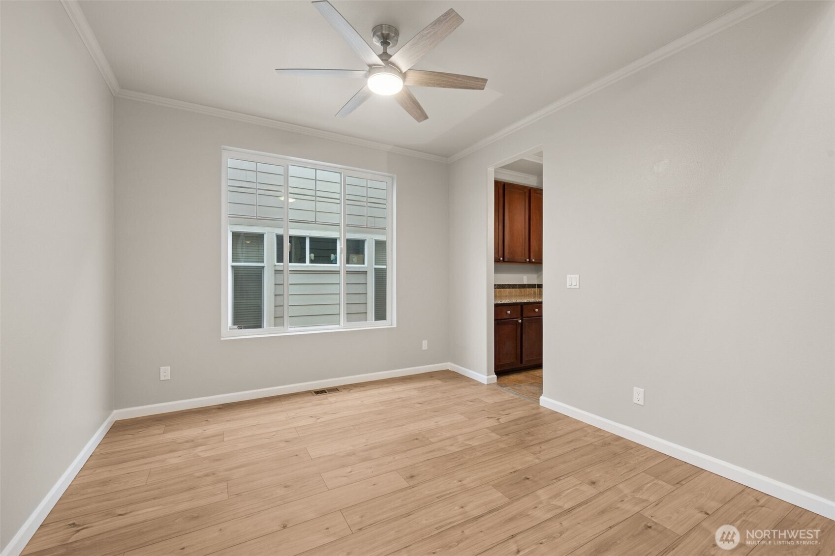 9248 Periwinkle Loop Northeast Olympia, WA 98516 - Photo 6 of 39 a view of an empty room with a window and wooden floor
