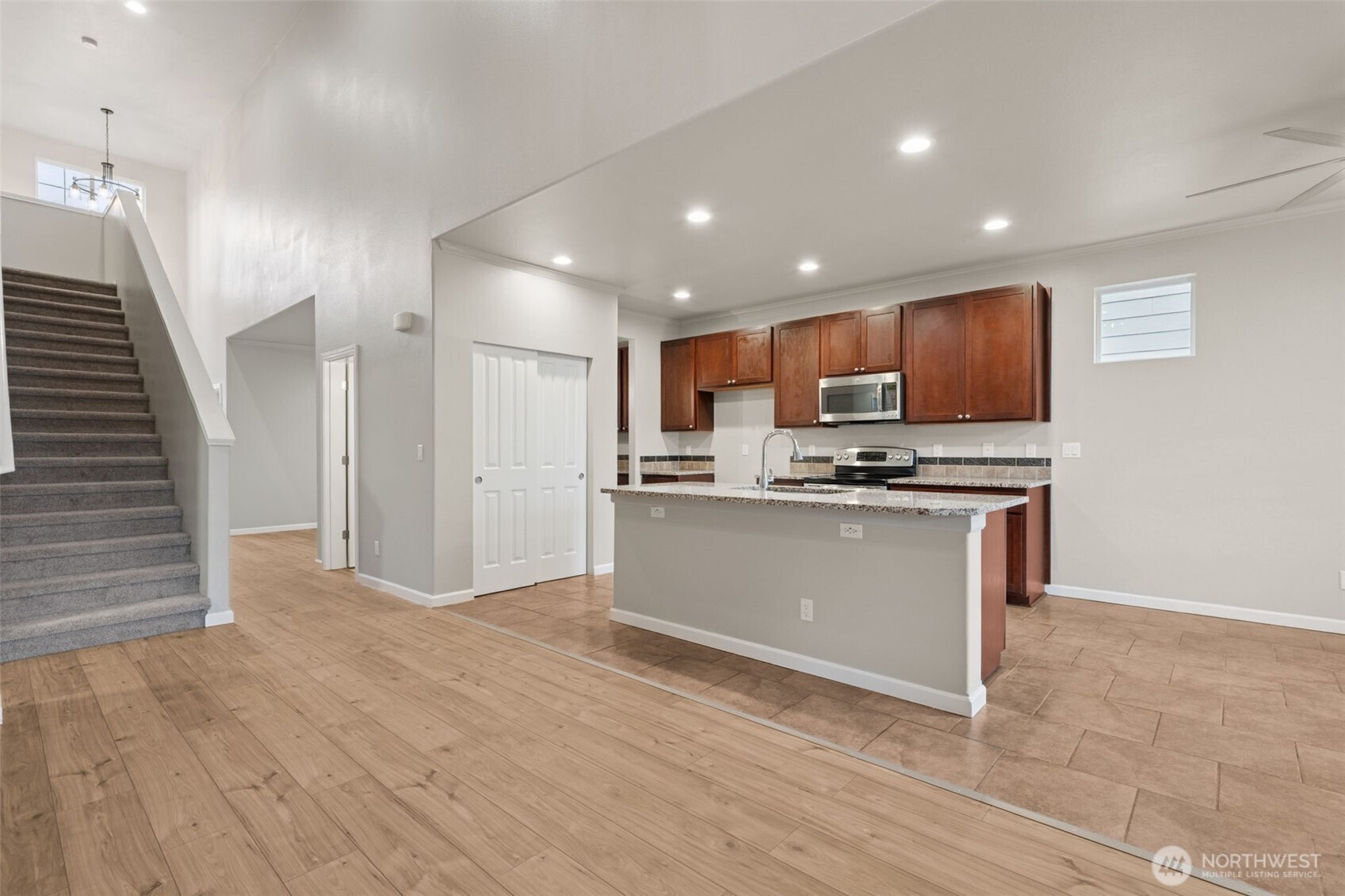 9248 Periwinkle Loop Northeast Olympia, WA 98516 - Photo 9 of 39 a view of kitchen with granite countertop cabinets and refrigerator