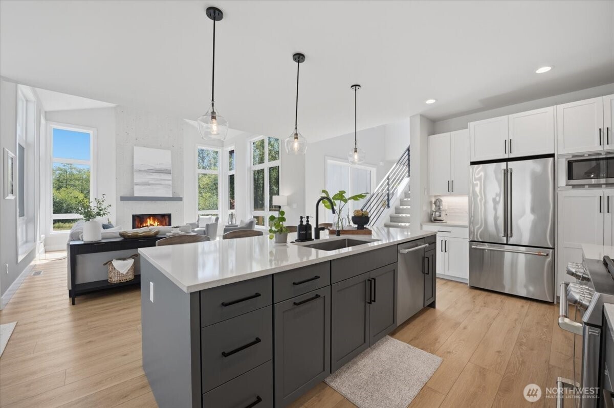 20580 Sinnes Road Mount Vernon, WA 98274 - Photo 14 of 39 a kitchen with stainless steel appliances a sink a stove a refrigerator and island with wooden floor