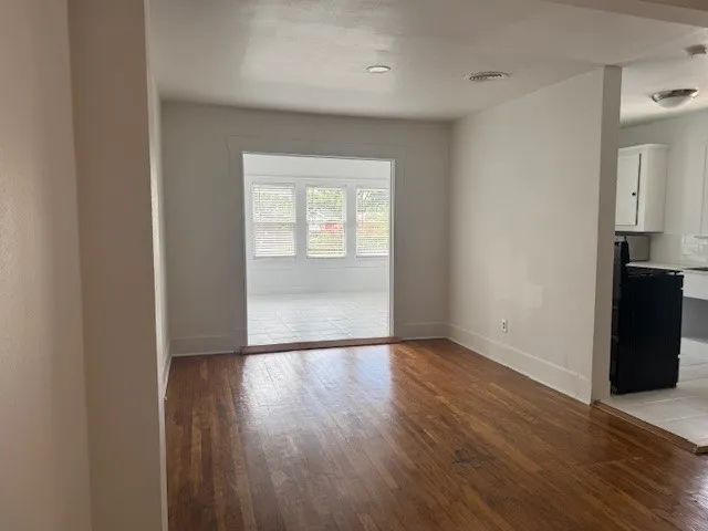a view of a hallway with wooden floor