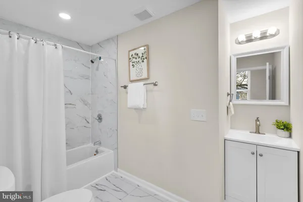 a bathroom with a shower curtain and a sink