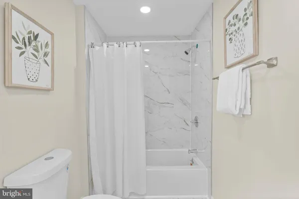 a bathroom with a shower and a toilet