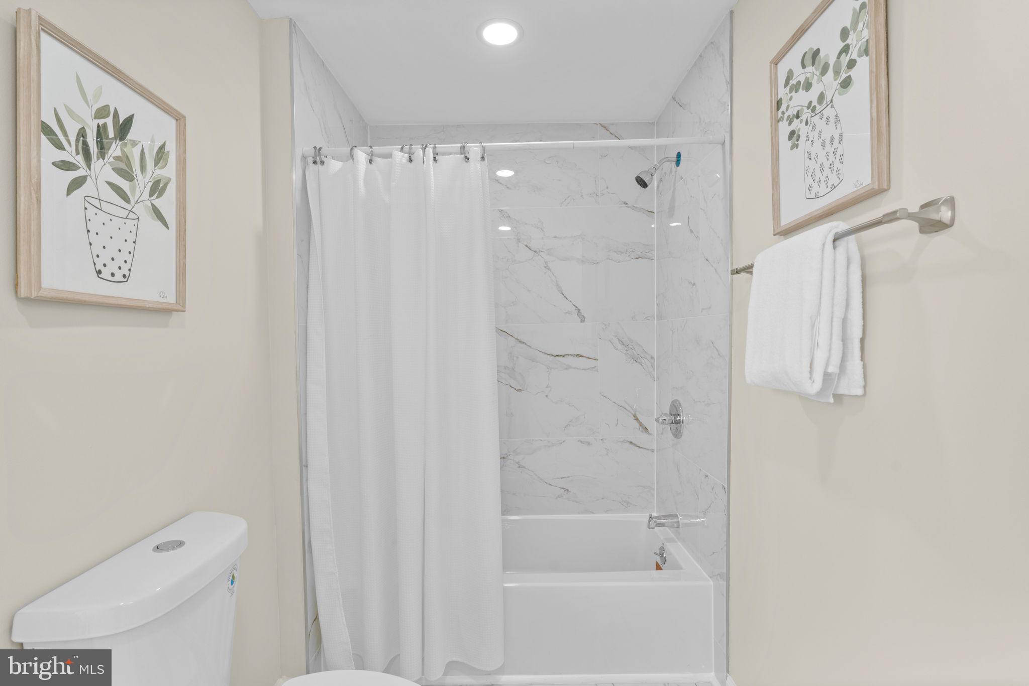 3111 Foster Avenue Baltimore, MD 21224 - Photo 12 of 28 a bathroom with a shower and a toilet