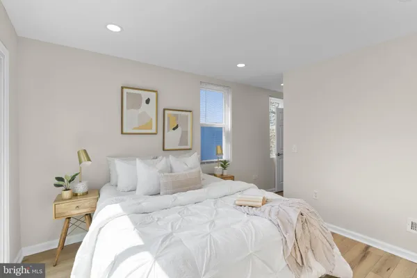 a bedroom with a bed and painting on the wall