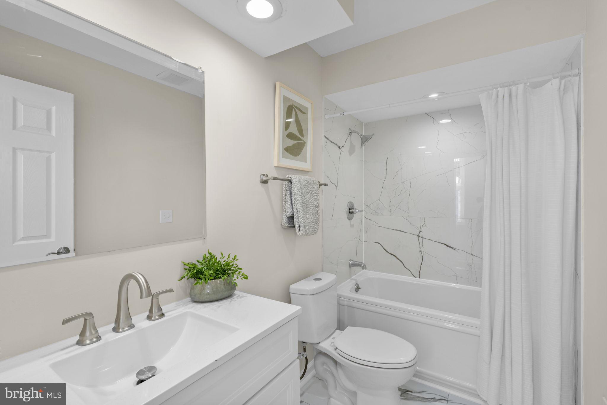 3111 Foster Avenue Baltimore, MD 21224 - Photo 15 of 28 a bathroom with a sink a toilet and shower