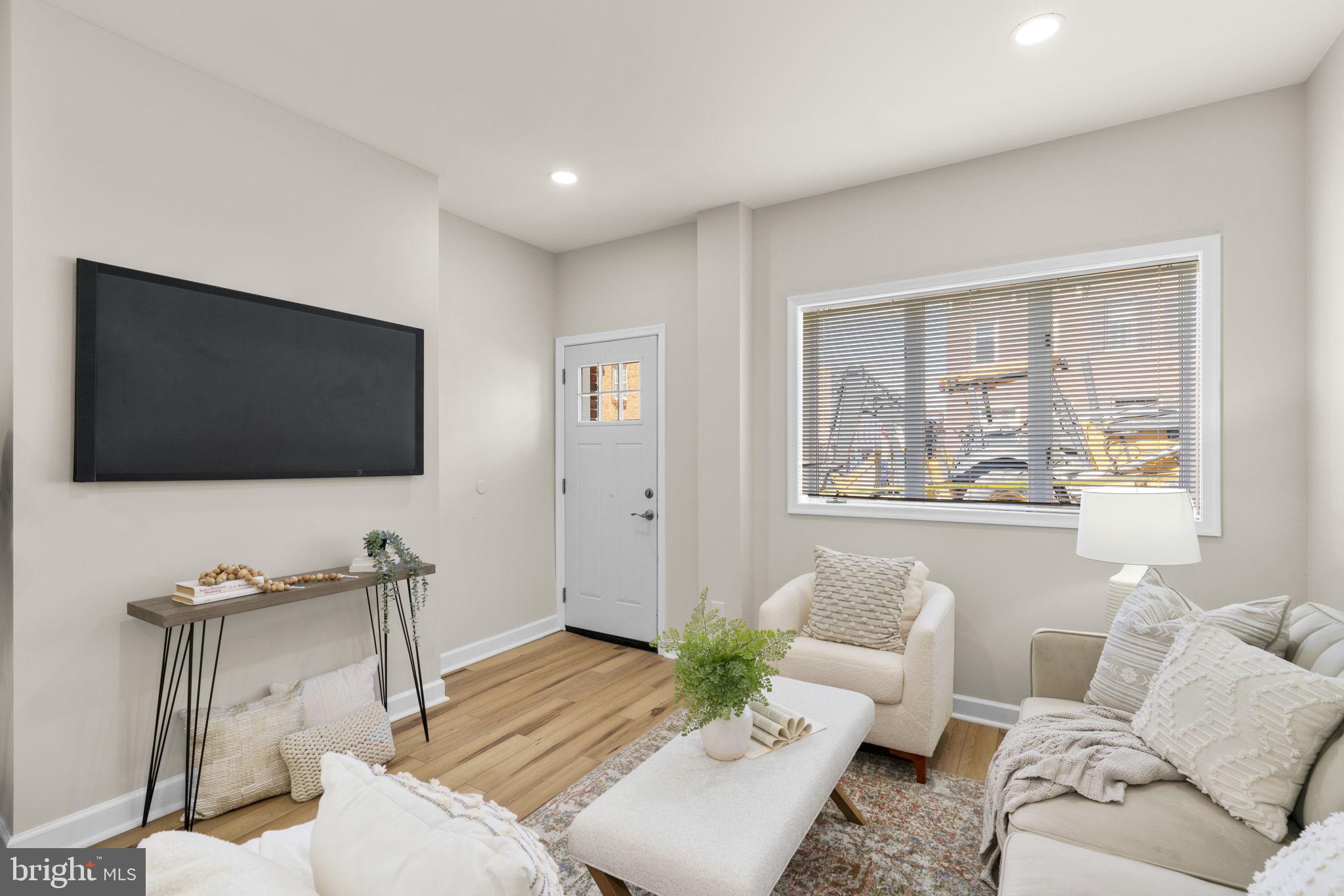 3111 Foster Avenue Baltimore, MD 21224 - Photo 2 of 28 a living room with furniture and a flat screen tv