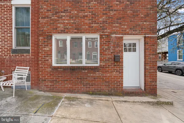 a view of a brick house with a bench