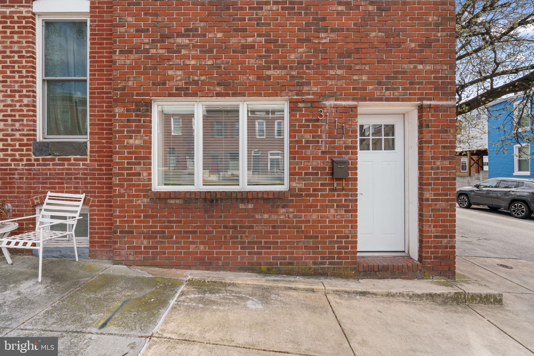3111 Foster Avenue Baltimore, MD 21224 - Photo 25 of 28 a view of a brick house with a bench