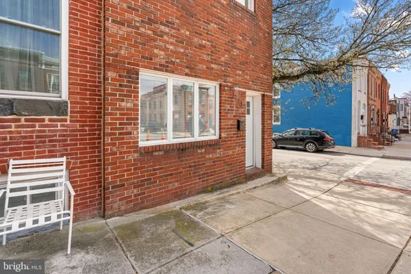 a view of a brick building next to a yard