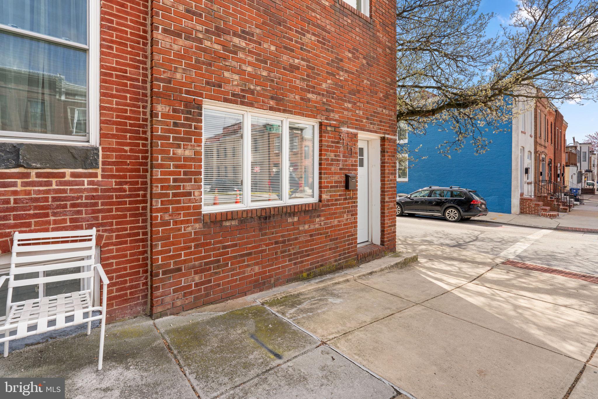 3111 Foster Avenue Baltimore, MD 21224 - Photo 26 of 28 a view of a brick building next to a yard