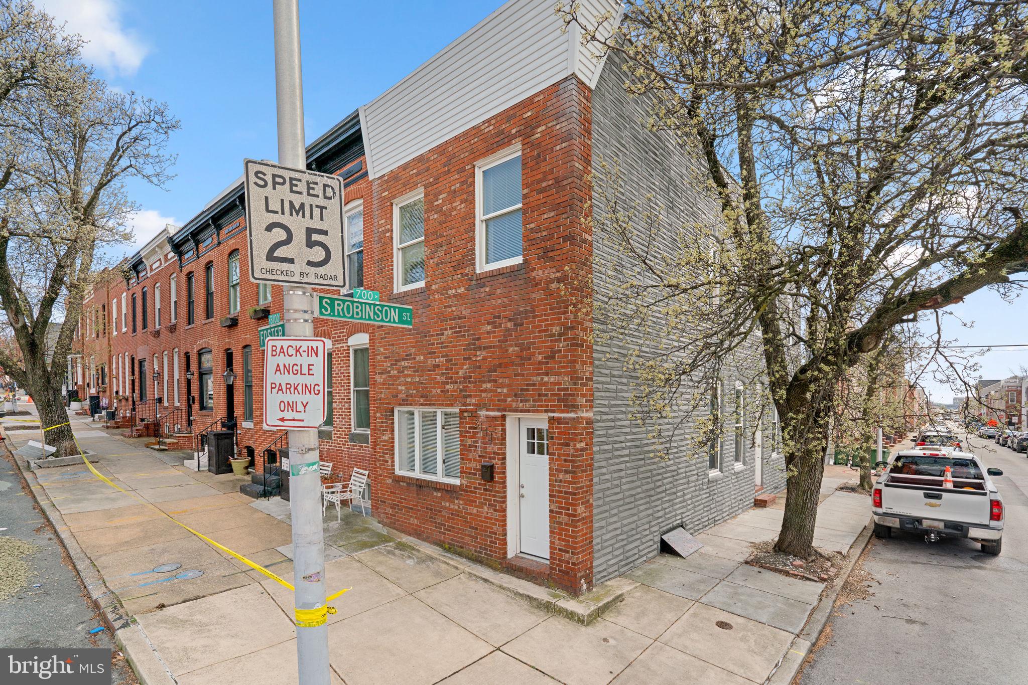 3111 Foster Avenue Baltimore, MD 21224 - Photo 28 of 28 a couple of cars parked in front of brick building