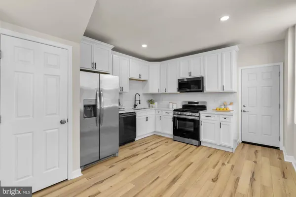a kitchen with a refrigerator stove and wooden cabinets