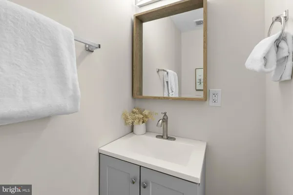 a bathroom with a sink a mirror and shower curtain