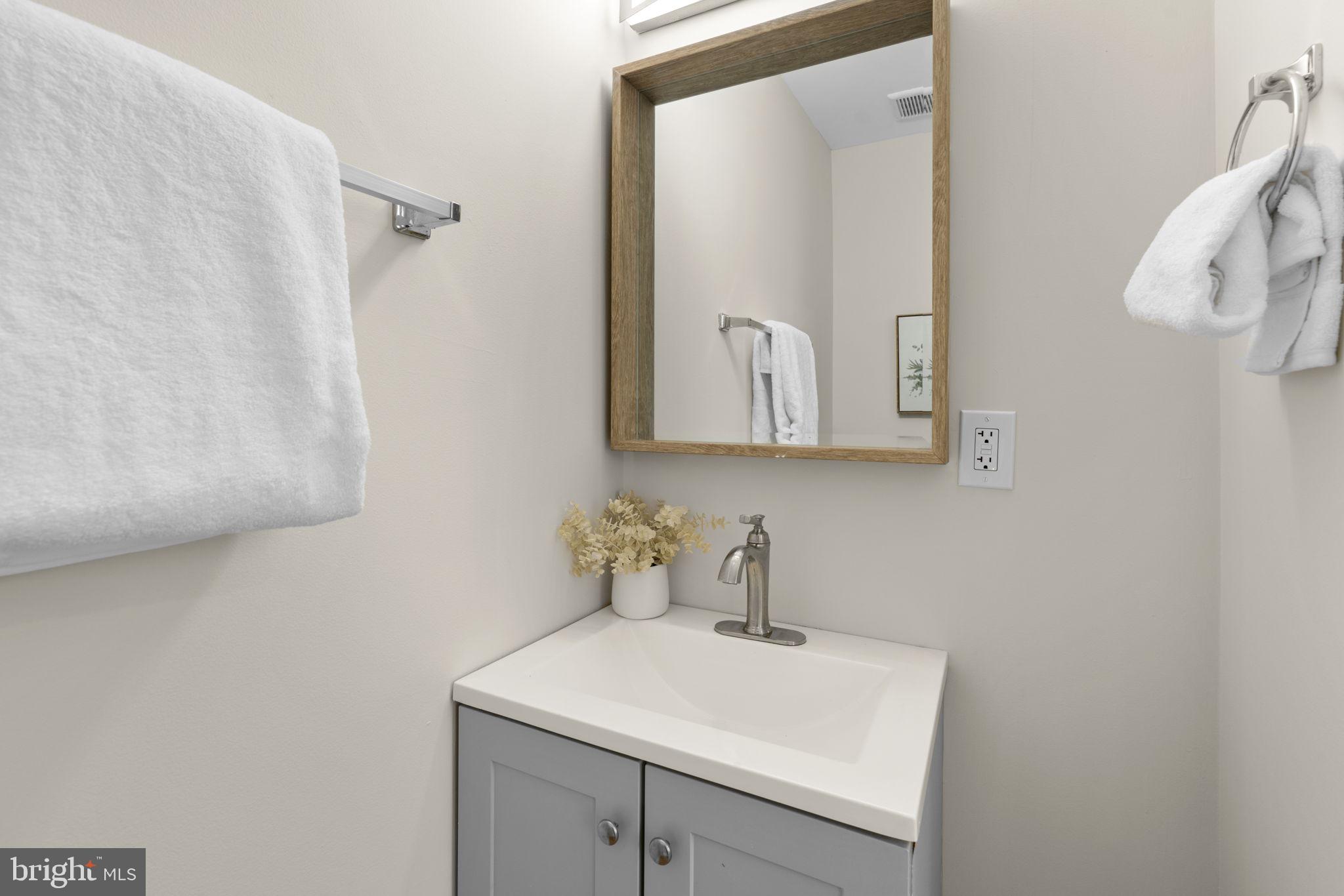 3111 Foster Avenue Baltimore, MD 21224 - Photo 8 of 28 a bathroom with a sink a mirror and shower curtain