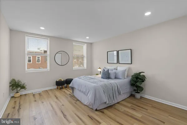 a bedroom with a bed and a potted plant