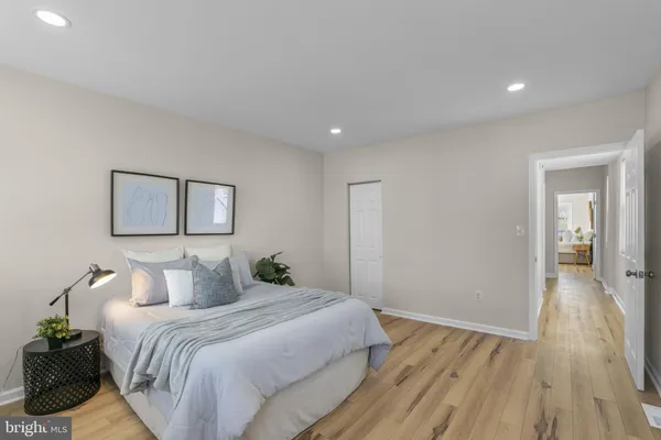 a bedroom with a bed and a painting on the wall