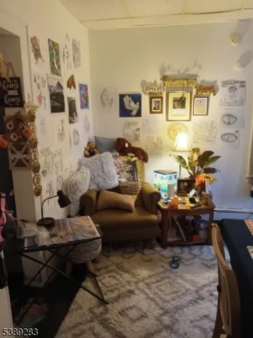 a living room with furniture and painting on the wall