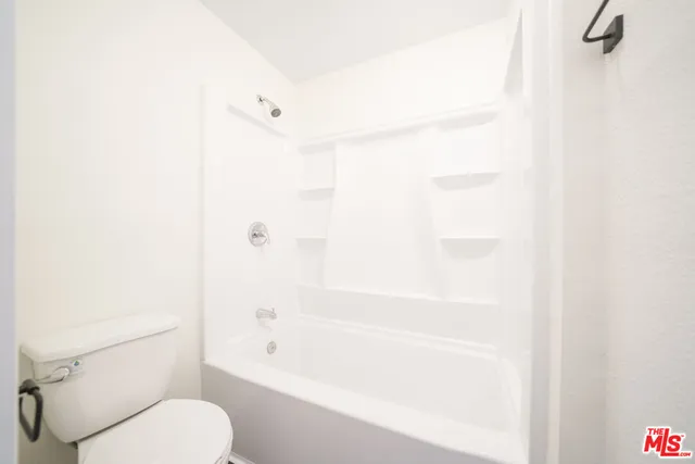 a bathroom with a toilet and a bathtub